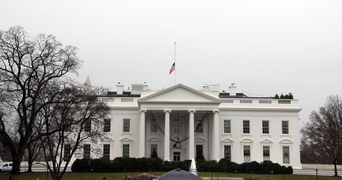 An American flag flies at half-staff above the White House in Washington on December 6.