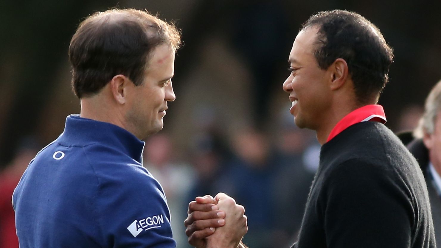 Zach Johnson (left) is congratulated by Tiger Woods following his playoff win against the world no.1 in California. 
