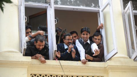 Arvind Kejriwal (center, holding microphone) addresses supporters from his office on December 8, 2013.