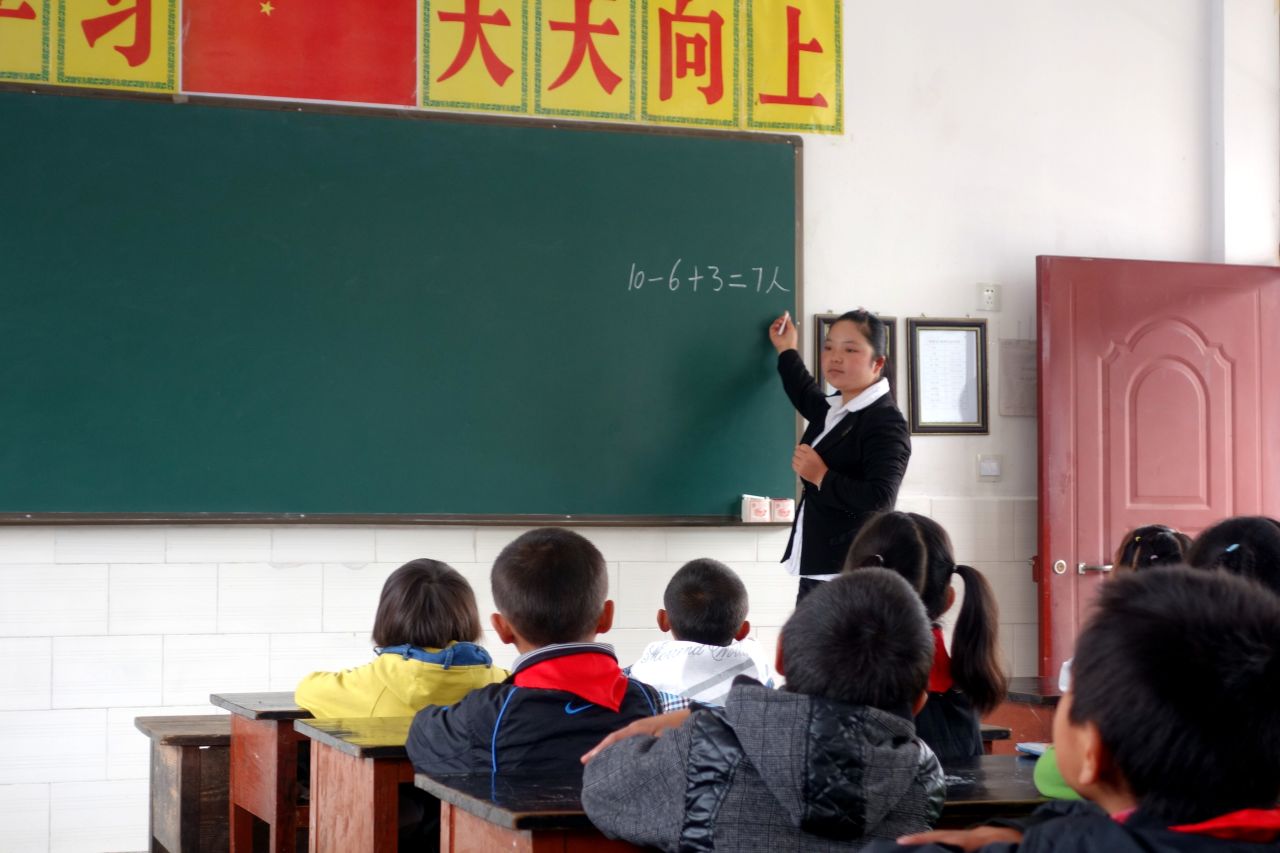 "Study hard and make progress everyday" reads a slogan on top of the blackboard.