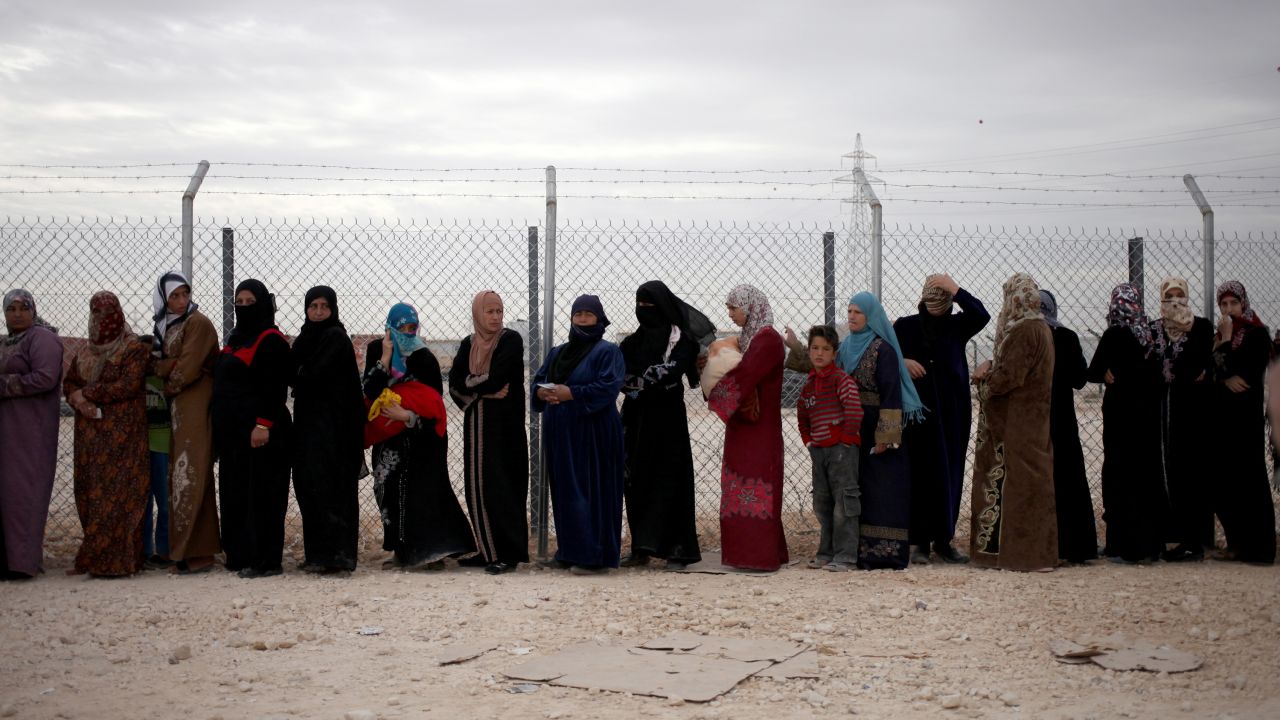 Syrian refugees wait in line to receive winter aid kits at the Zaatari refugee camp near Mafraq, Jordan, on Tuesday, December 3.