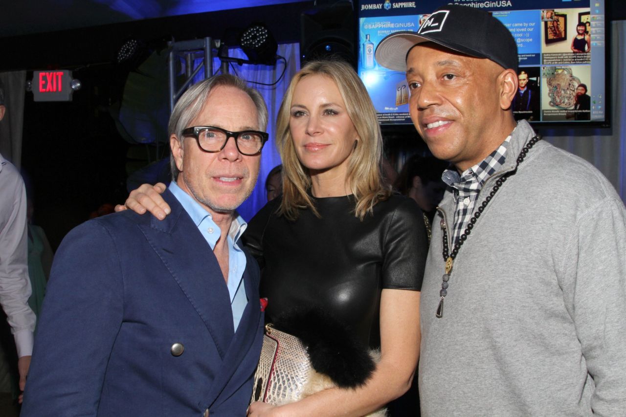 In 2011 fashion designer Tommy Hilfiger acquired a Damien Hirst work entitled "Disintegration -- The Crown of Life" for $1.4 million. Here Hilfiger and his wife mingle with Russell Simmons at an Art Basel event hosted by Bombay Sapphire.