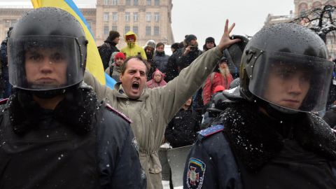 A protester shouts behind riot police standing guard in Independence Square on December 9. 