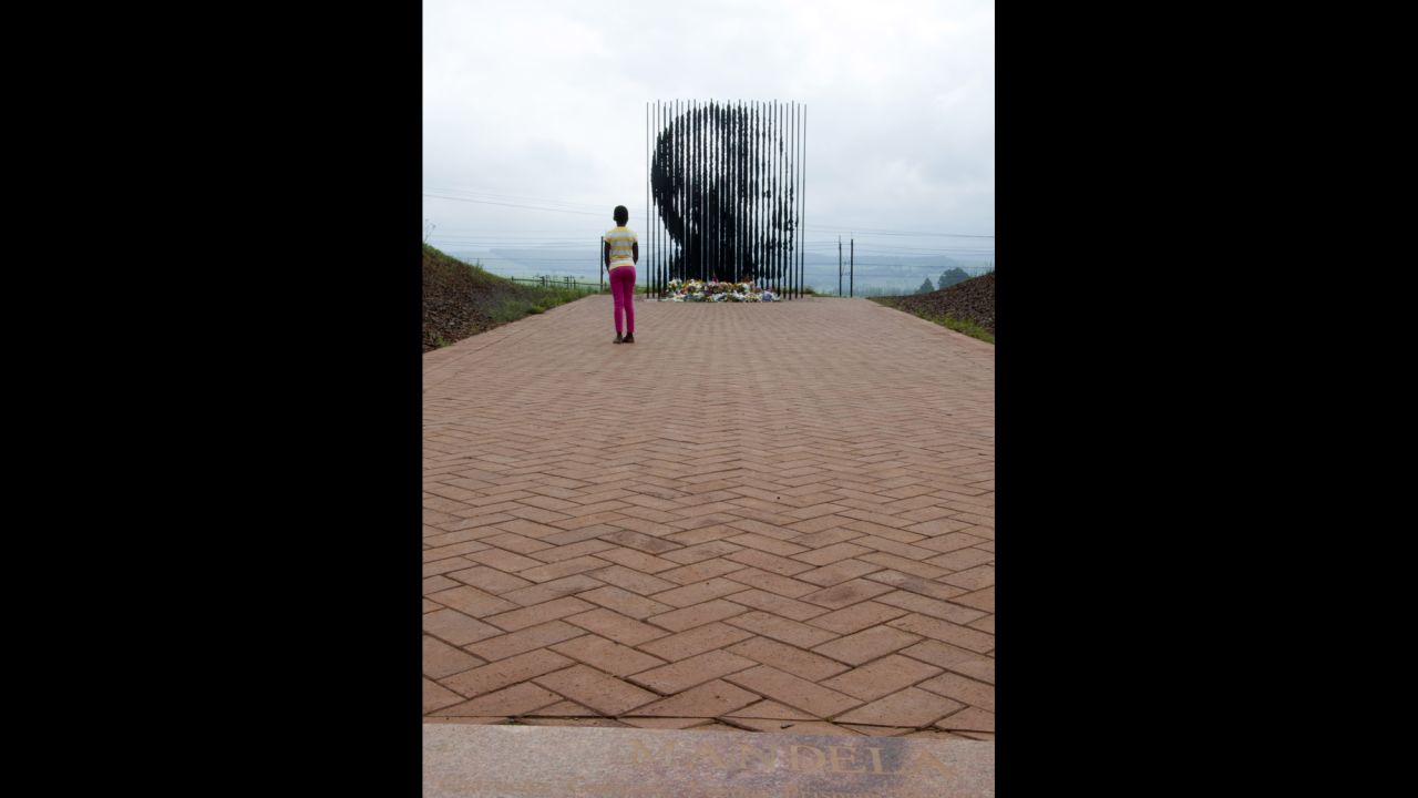 A child checks out at a sculpture of Mandela by Marco Cianfanelli near Howick, South Africa, on December 9.
