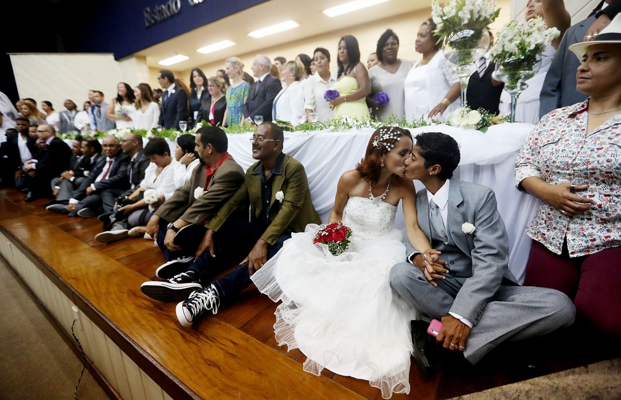 DECEMBER 9 - RIO DE JANEIRO, BRAZIL: Newly-married couple Emmanuela and Romilda (lower right) kiss at what was billed as the world's largest communal gay wedding. One hundred and thirty couples were married at the event, held at the Court of Justice in downtown Rio. In May,<a href="http://cnn.com/2013/05/15/world/americas/brazil-same-sex-marriage/"> Brazil became the third country in Latin America to approve same-sex marriage</a> via a court ruling, but a final law is yet to be passed.