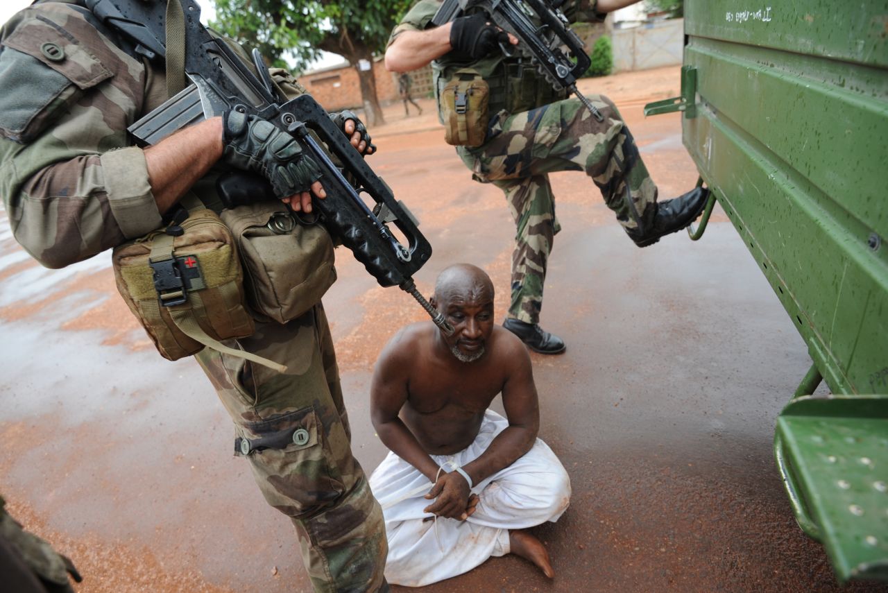 French soldiers stand guard near a man they have arrested in Bangui on December 9.