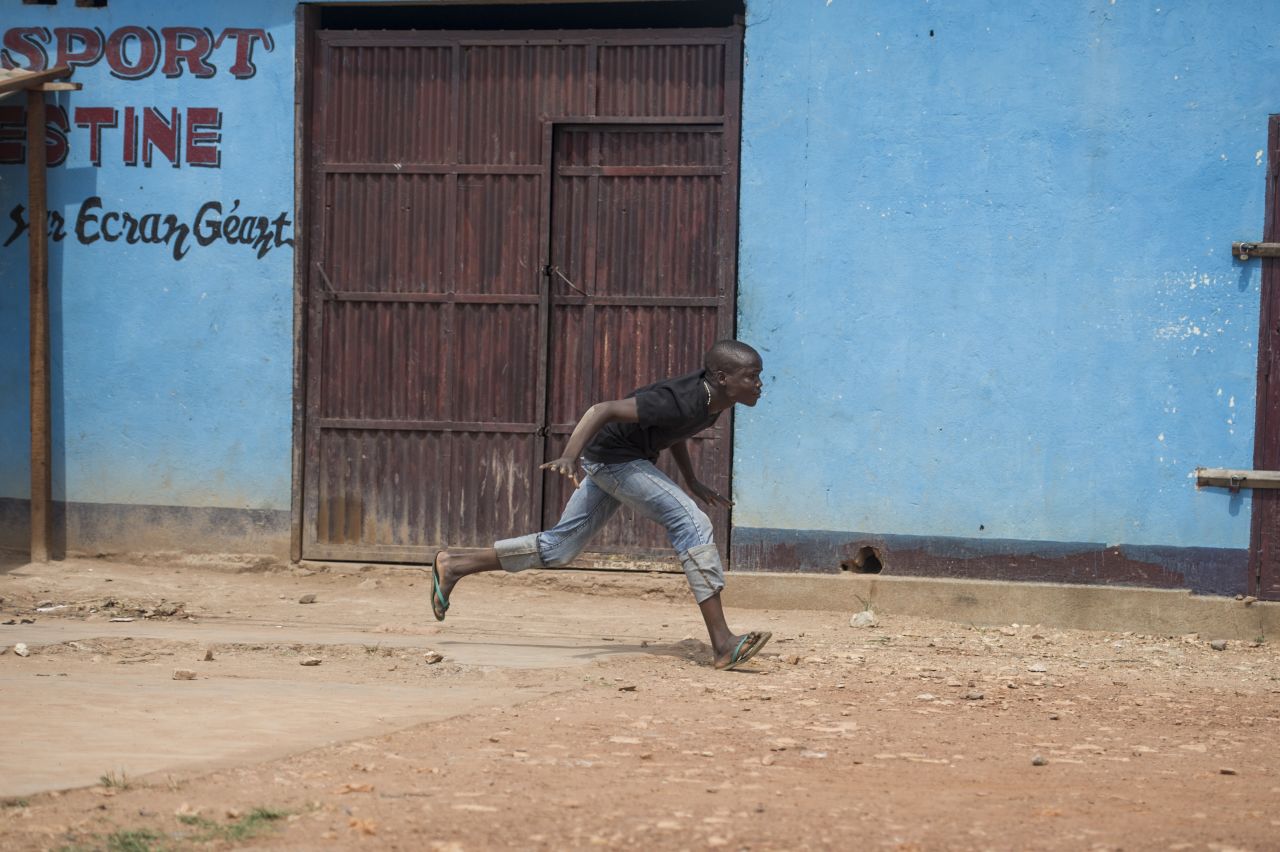 A man runs from gunfire December 9 during a disarmament operation by French soldiers in Bangui.