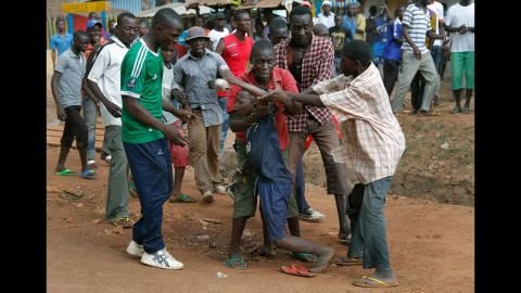 Mobs of Christians grab a child holding a knife in Bangui on December 9.