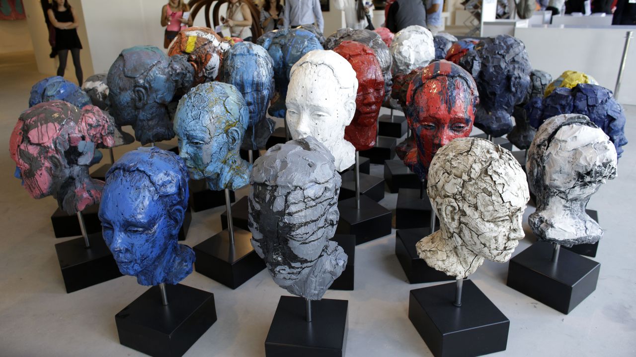 An installation of 40 heads made of cast resin by artist Lionel Smit titled "Accumulation of Disorder" is displayed at Art Miami,  December 8. Art Miami is one of numerous satellite fairs that run in conjunction with Art Basel. 