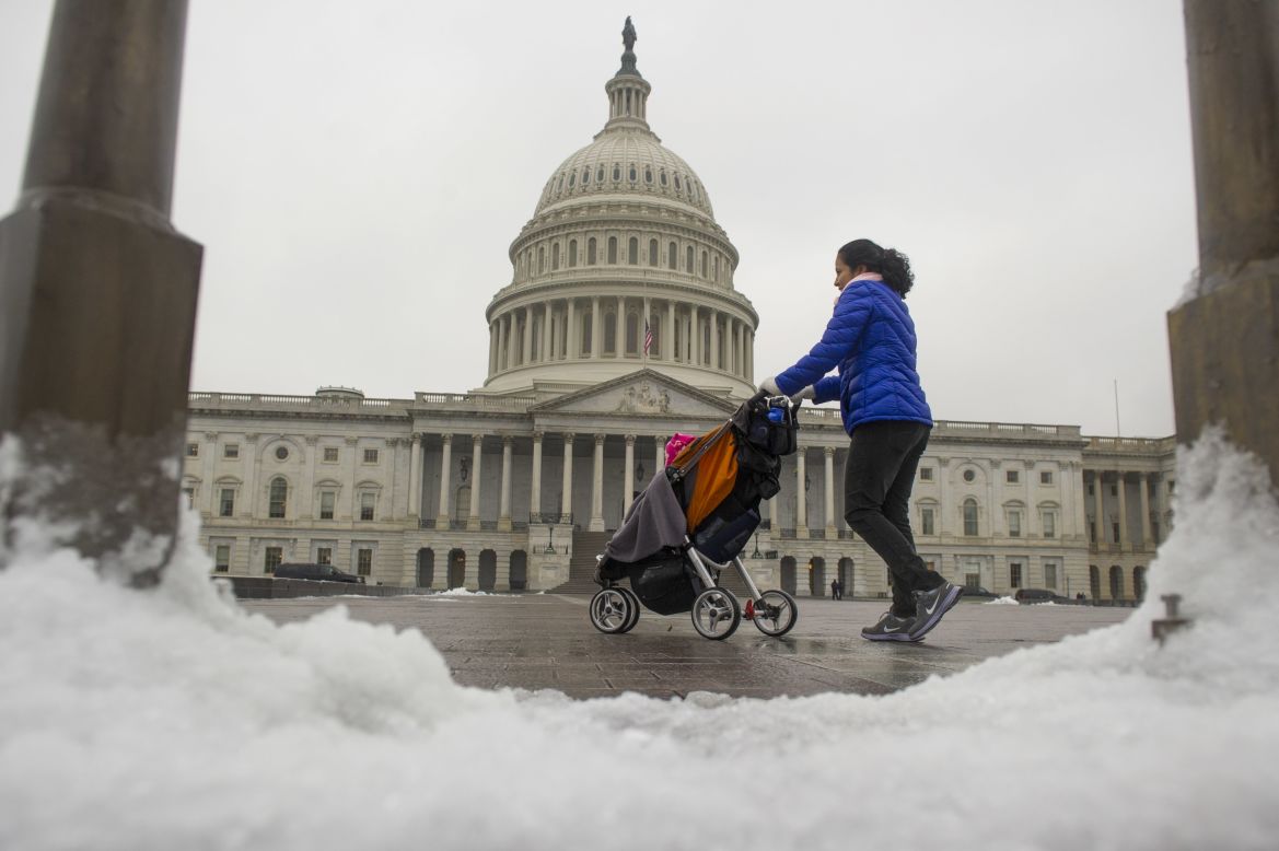  A woman strolls past the Capitol Building in Washington on December 9, after an overnight ice storm hit the region. Federal agencies opened two hours late because of the weather.