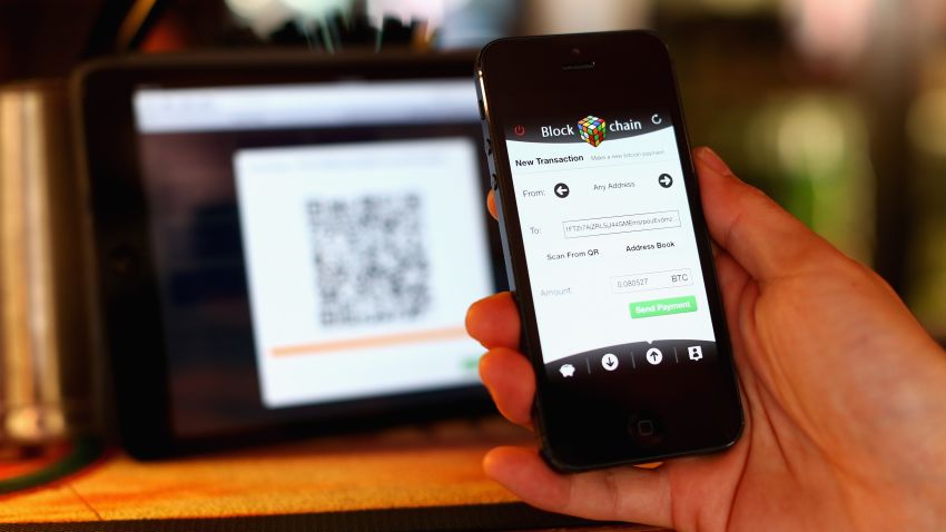 In this photo illustration, a customer scans a QR code to pay for drinks using bitcoins on September 19, 2013 in Sydney, Australia. The Old Fitzroy pub in Sydney's eastern suburbs will accept the digital currency, Bitcoin, as of Next Sunday. Using a smartphone and a QR code scanning application customers will be able to purchase beer and menu items at the bar. The Old Fitzroy is the first Australian pub to accept Bitcoin payment.