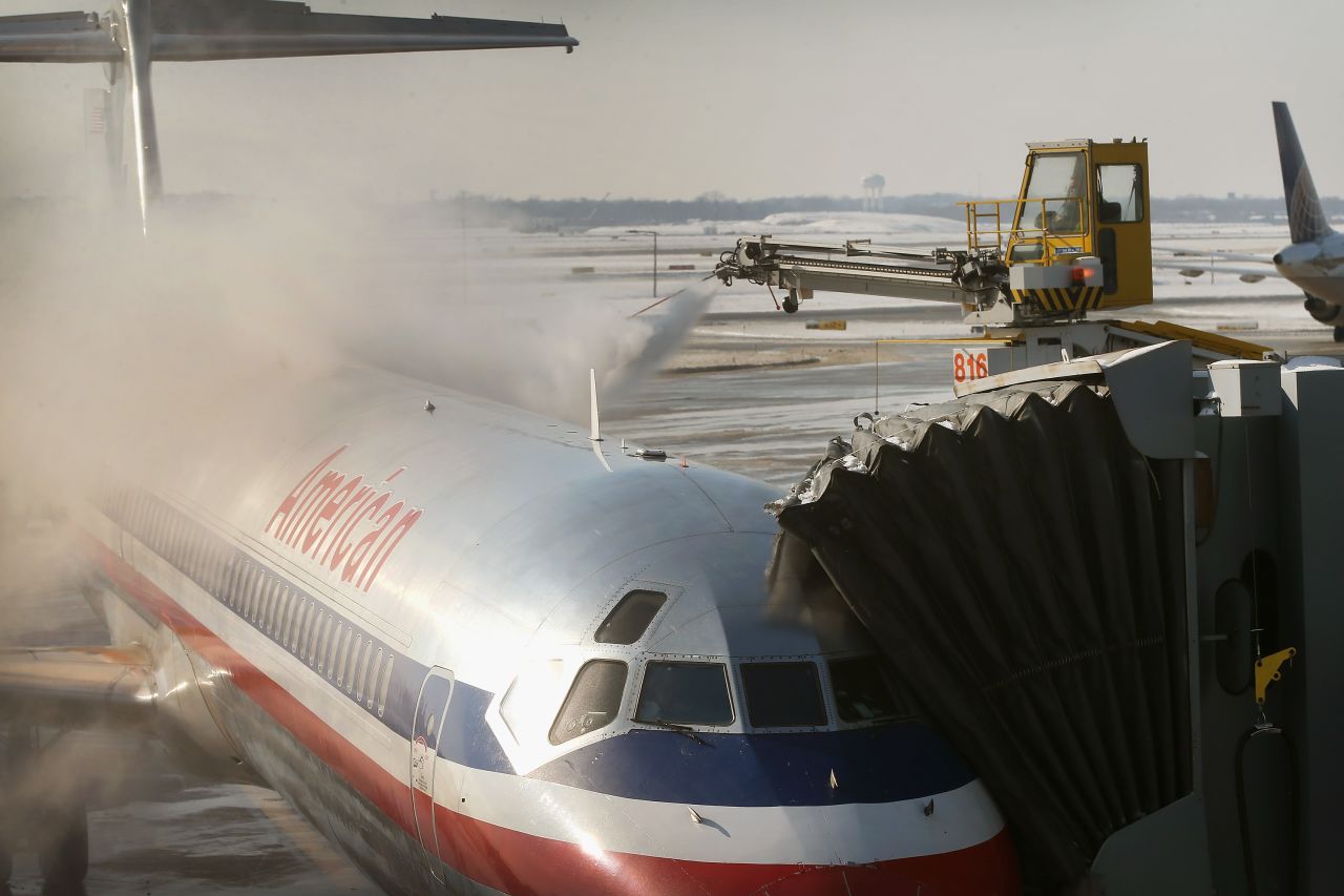 An American Airlines jet is de-iced at O'Hare Airport in Chicago on December 9. Wintry conditions have caused numerous flight cancellations and delays.