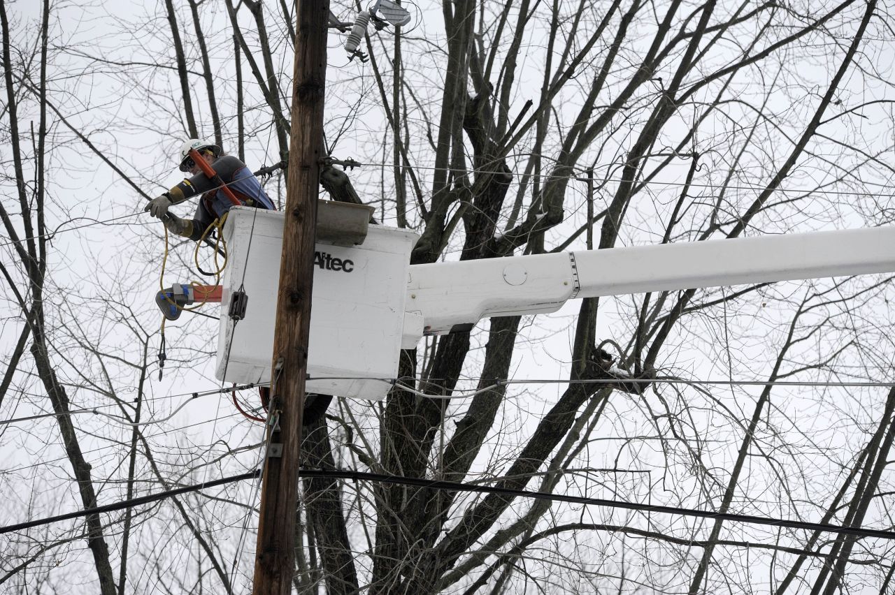 Baltimore Gas & Electric lineman Jim Thompson repairs a power line that was damaged by a tree limb in Towson, Maryland, on Monday, December 9.