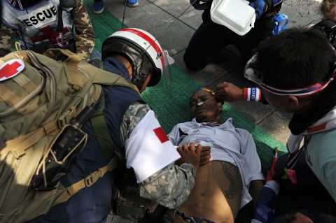 Rescuers treat a Thai anti-government protester after he fainted from exhaustion during a rally outside Government House in Bangkok on December 9.