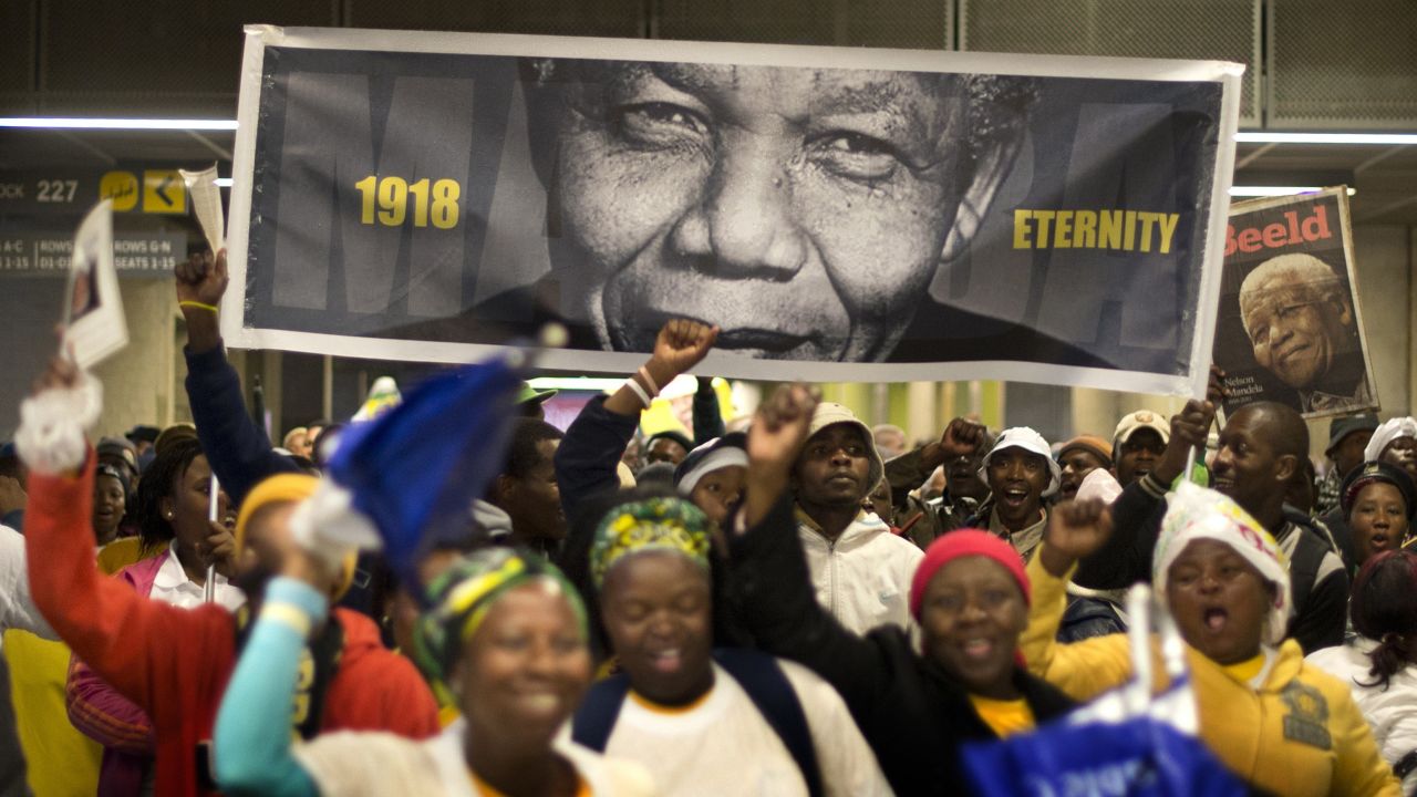 People arrive at FNB Stadium before the memorial service.
