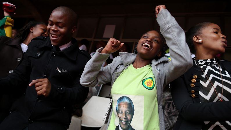 People celebrate Mandela at a telecast of the memorial service at Ellis Park in Johannesburg.