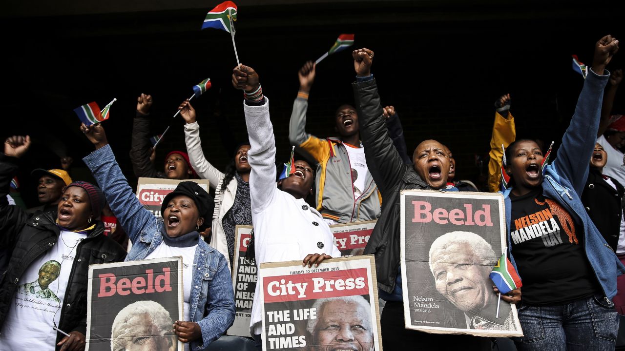 People watch a telecast of the memorial service inside Orlando Stadium in Soweto, which played an important role in the uprisings against apartheid.