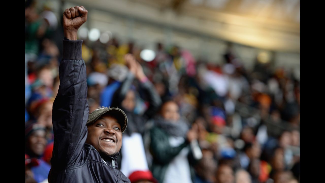 A man raises his fist during the memorial service.
