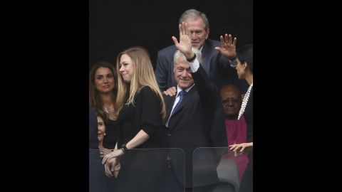 Former Presidents Bill Clinton and George W. Bush wave during the memorial service. Chelsea Clinton is at left.