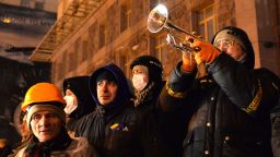 A man plays a trumpet as he call protesters to be ready for police attack at Kiev's City Hall on December 10, 2013.