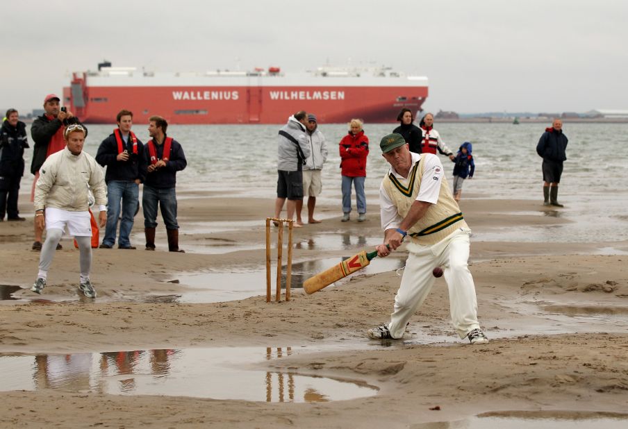 Massive container ships pass in the background, while other smaller vessels also get a close view of the temporary cricket wicket.