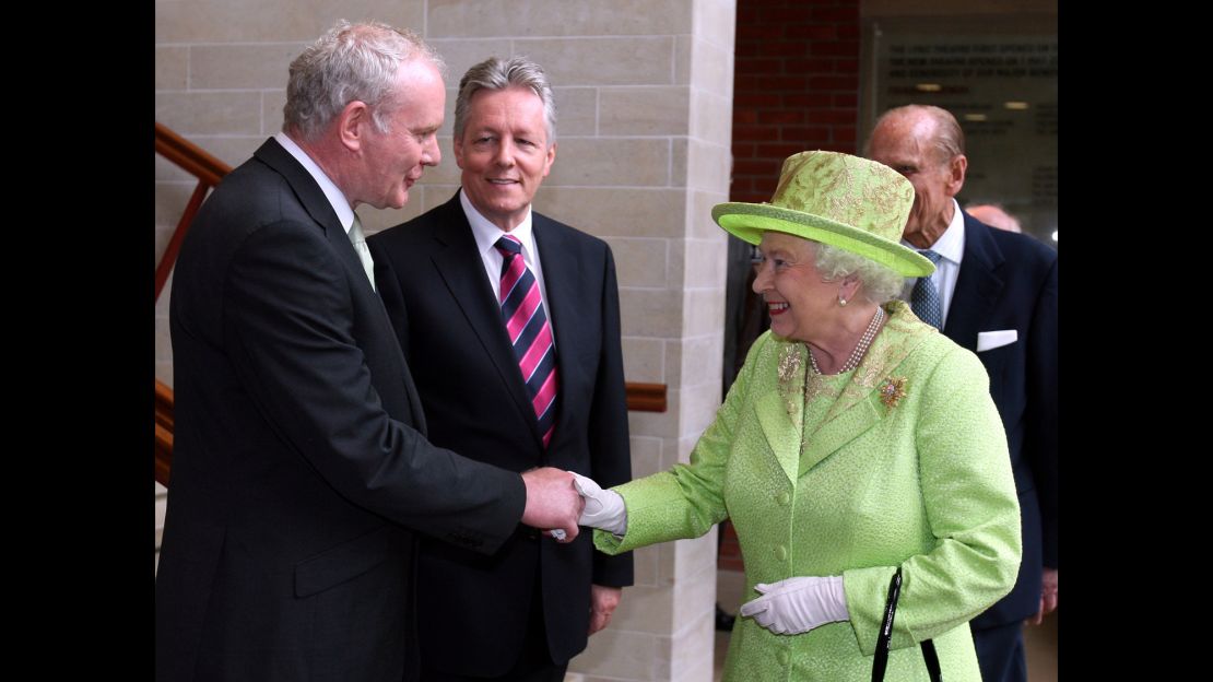 Queen Elizabeth II shakes hands with Deputy First Minister of Northern Ireland Martin McGuinness as First Minister Peter Robinson looks on at the Lyric Theatre on June 27, 2012 in Belfast, Northern Ireland.  