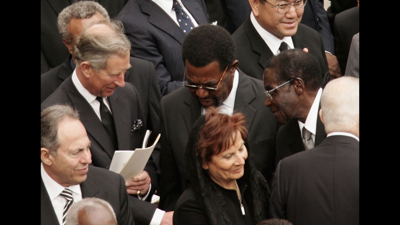 Prince Charles shakes hands with Zimbabwe's President Robert Mugabe during Pope John Paul II's funeral in St. Peter's Square on April 8, 2005, in Vatican City. 