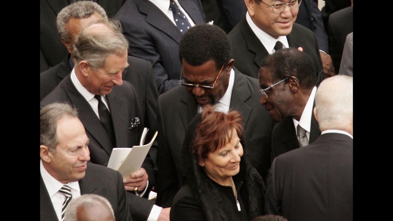 Prince Charles shakes hands with Zimbabwe's President Robert Mugabe during Pope John Paul II's funeral in St. Peter's Square on April 8, 2005, in Vatican City.