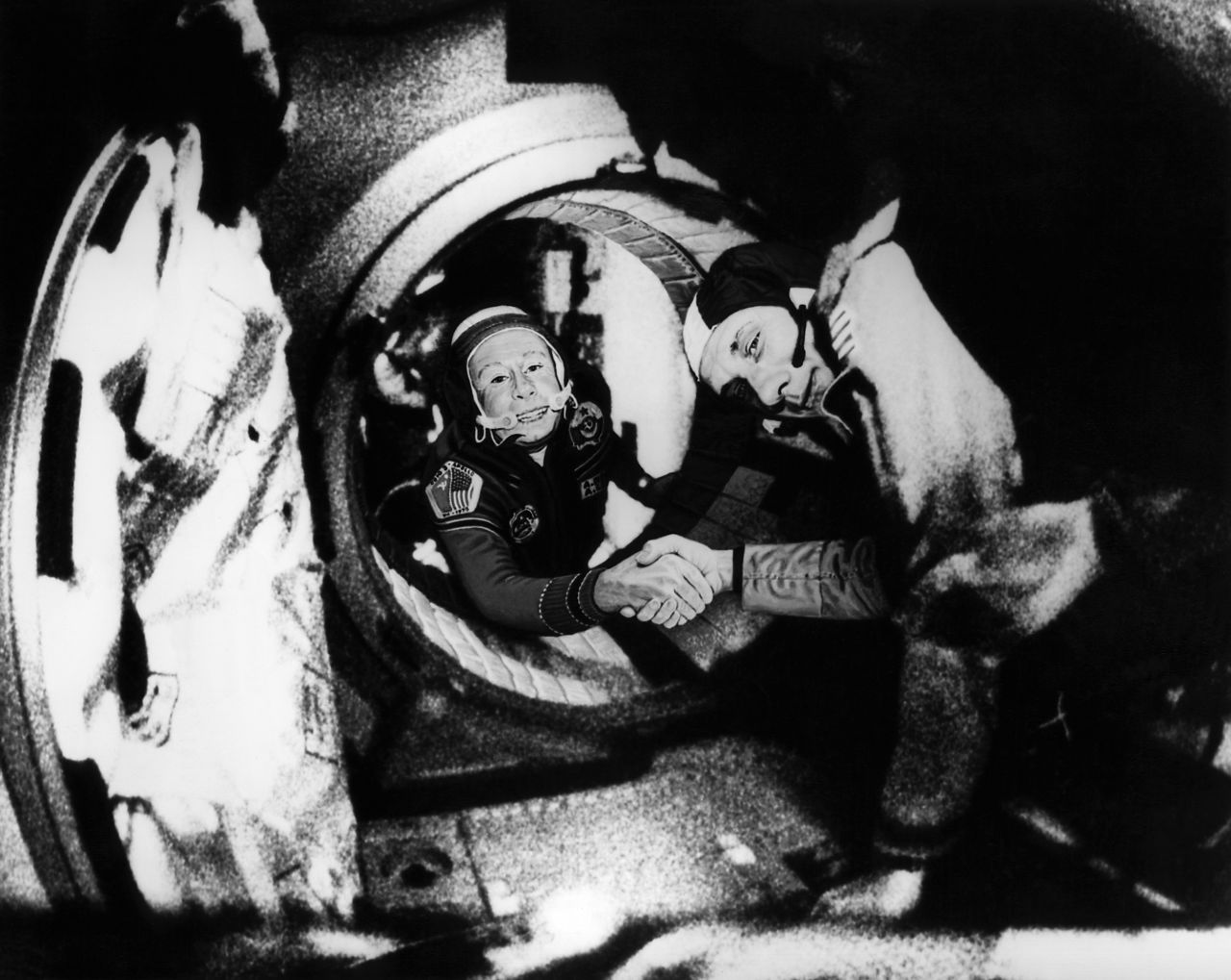 During a thaw in the Cold War, Commander of the Soviet crew of Soyuz, Alexei Leonov, left, and commander of the American crew of Apollo, Thomas Stafford, shake hands on July 17, 1975, in space, somewhere over West Germany, after Apollo-Soyuz docking maneuvers.