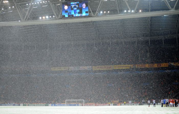 Snow teaming down at the Turk Telekom Arena in Istanbul on Tuesday night. Despite the best efforts of ground staff to make the pitch playable, the game was eventually abandoned. UEFA say the match will resume at 12pm GMT on Wednesday.  