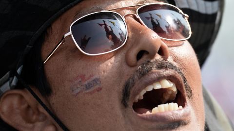 The flags of anti-government protesters are reflected in a protester's glasses in Bangkok on December 9, 2013. 