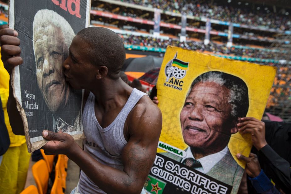 People attend the memorial service for former South African President Nelson Mandela at FNB Stadium in Johannesburg on Tuesday, December 10. Thousands of South Africans and more than 90 heads of state gathered to honor the revered leader, who died Thursday, December 5. He was 95.