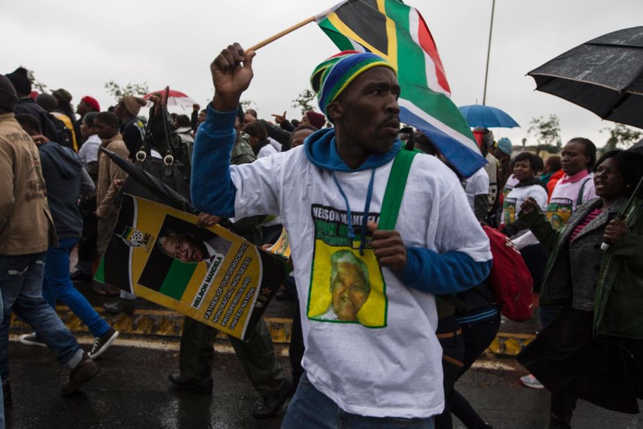 Mandela supporters make their way to the stadium.