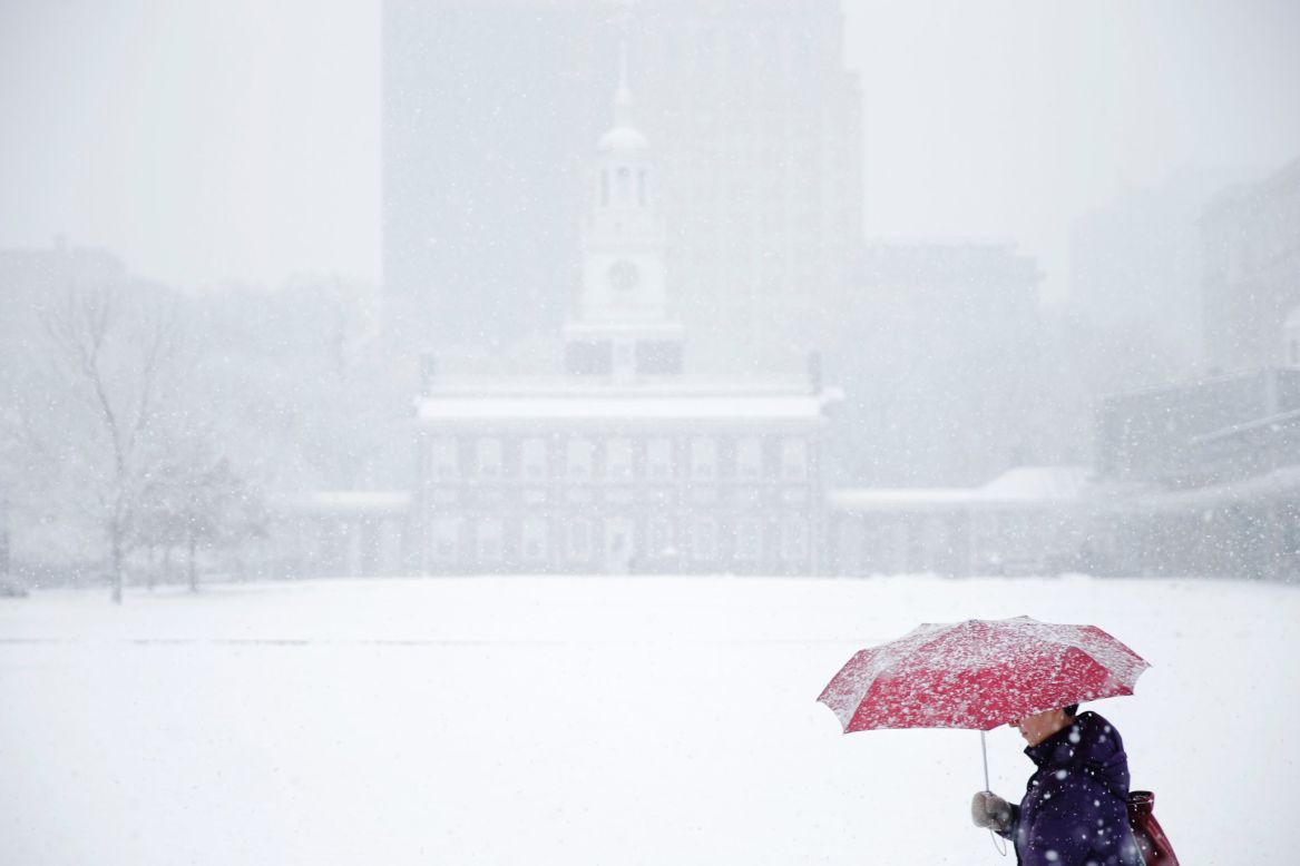 A woman walks past Independence Hall during a snowstorm in Philadelphia on December 10.