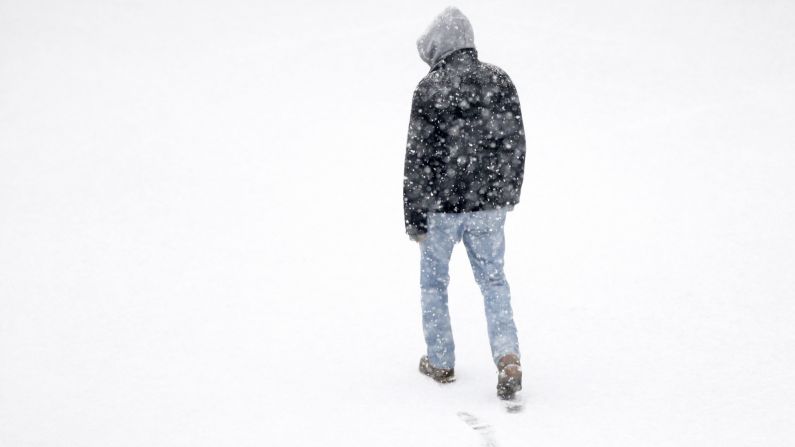 A man makes his way across a parking lot during a snowstorm in Philadelphia on December 10.