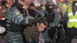 Ukrainian riot policemen pull an activist out form a tent camps on the Independence Square in Kiev, Ukraine, Wednesday, Dec. 11, 2013.