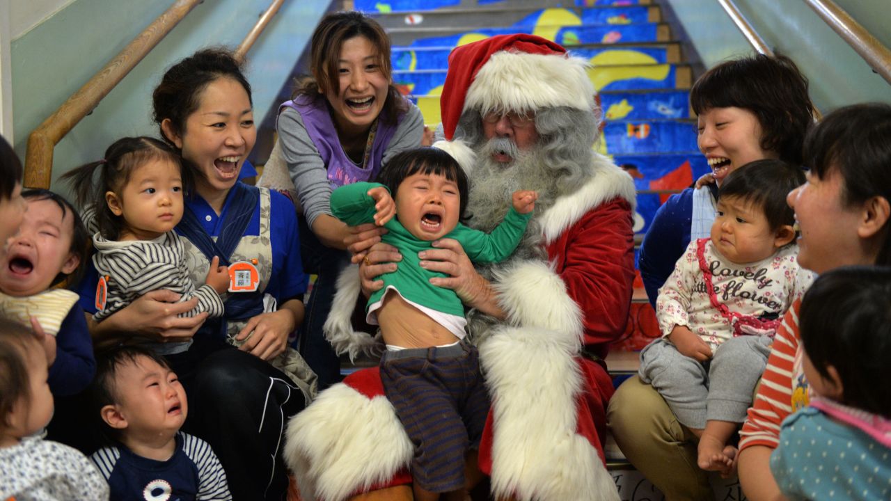 A man playing Santa Claus entertains children at a nursery school in Tokyo on December 9.