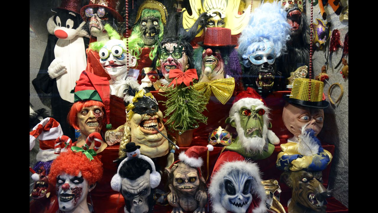 These horror masks, seen in a Madrid window display on December 9, lend a frightening air to the holiday season.