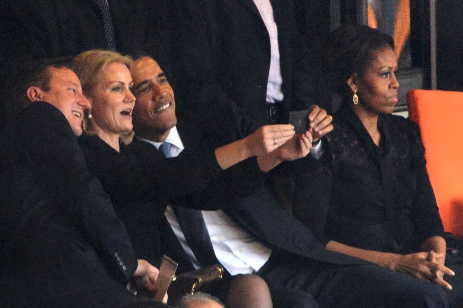 All together now, smile! <br />Obama poses for a selfie with Helle Thorning-Schmidt, known as "Gucci Helle" in her country for her love of designer clothes, and Cameron. First Lady Michelle Obama looks elsewhere.