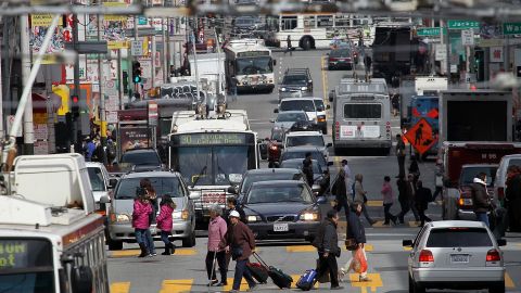 Cars and buses share the road along Stockton Street in San Francisco.