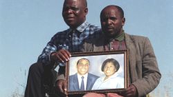 The brothers of Griffiths Mxenge hold up a picture of him and his wife, Victoria. Both Griffiths, a human rights lawyer, and Victoria, were brutally murdered by the apartheid security police. 