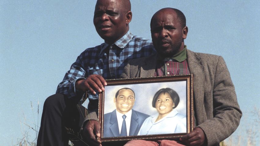 The brothers of Griffiths Mxenge hold up a picture of him and his wife, Victoria. Both Griffiths, a human rights lawyer, and Victoria, were brutally murdered by the apartheid security police.