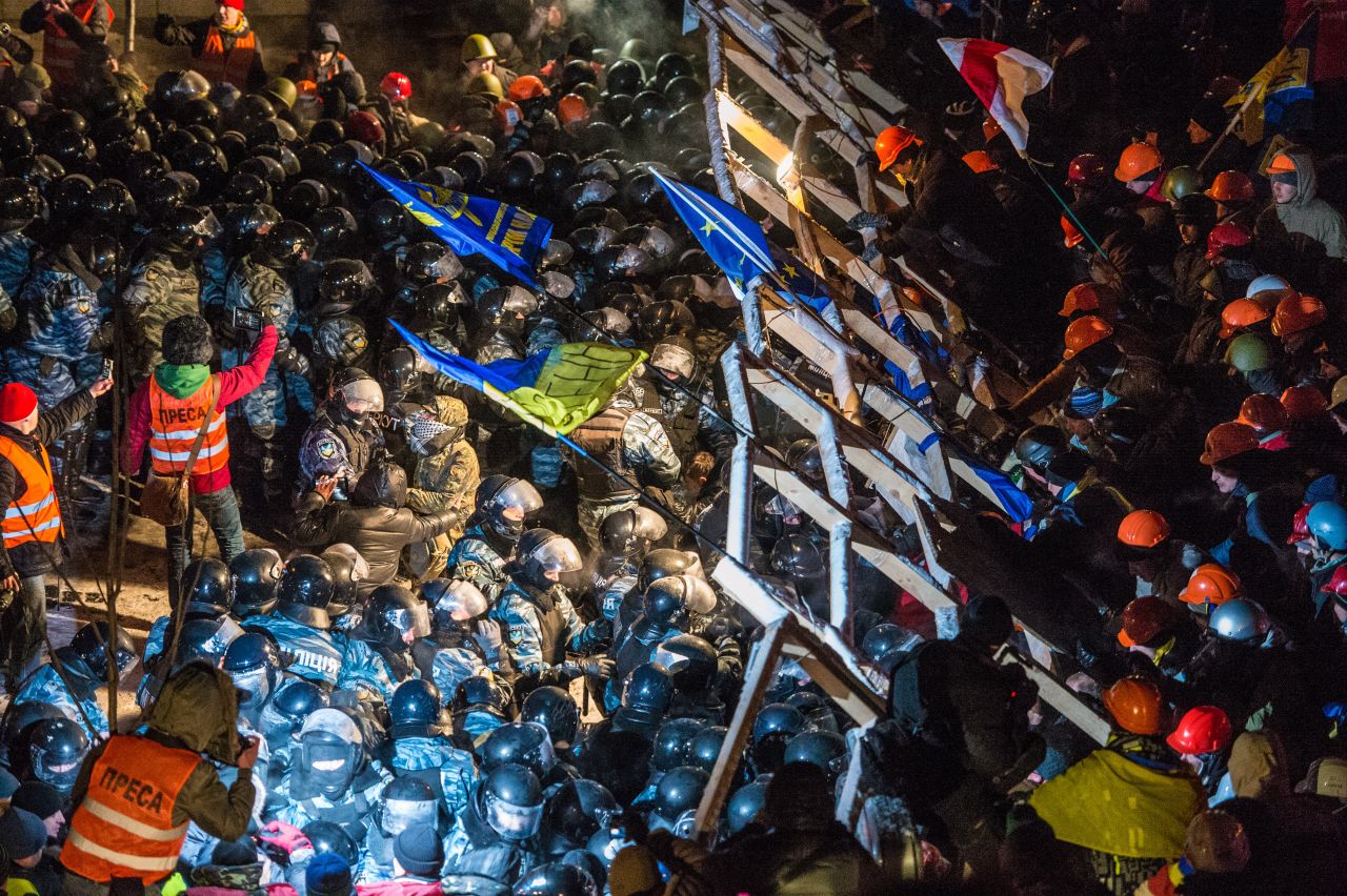 Riot police storm barricades set up by pro-EU protesters in Independence Square on Wednesday, December 11. 