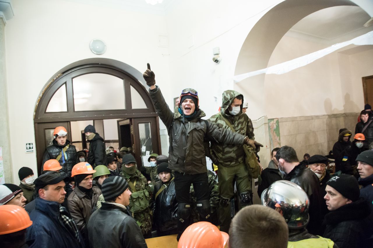 A protester calls for attention inside Kiev's City Hall after riot police were forced out from blocking the front door on December 11.