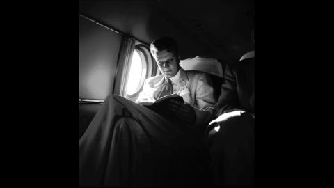Graham reads on an airplane during a "Pulpit in the Sky" trip in 1953.