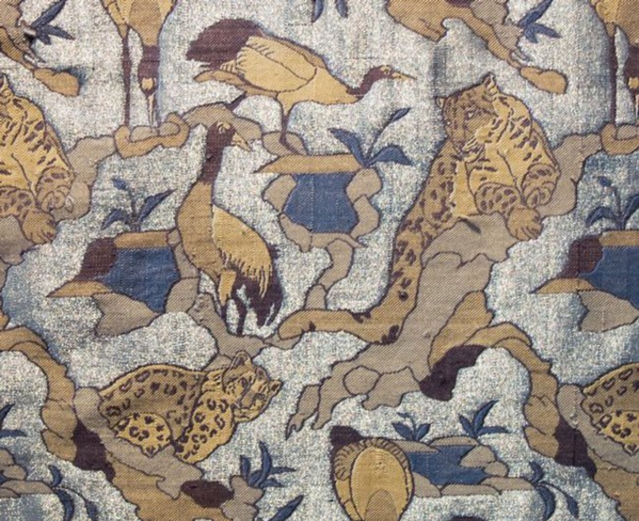 Textile designer Rahul Jain set up a workshop in Varanasi in India to recreate magnificent silk textiles of the past. The workshop has five drawlooms, at which local Muslim weavers work in pairs. This is a details from <em>The Snow Leopard</em> made from drawloom-woven silk and silver gilt thread.