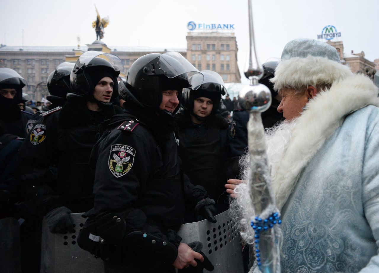 A man dressed as Santa Claus addresses riot police on Independence Square in Kiev, Ukraine, on Wednesday, December 11.