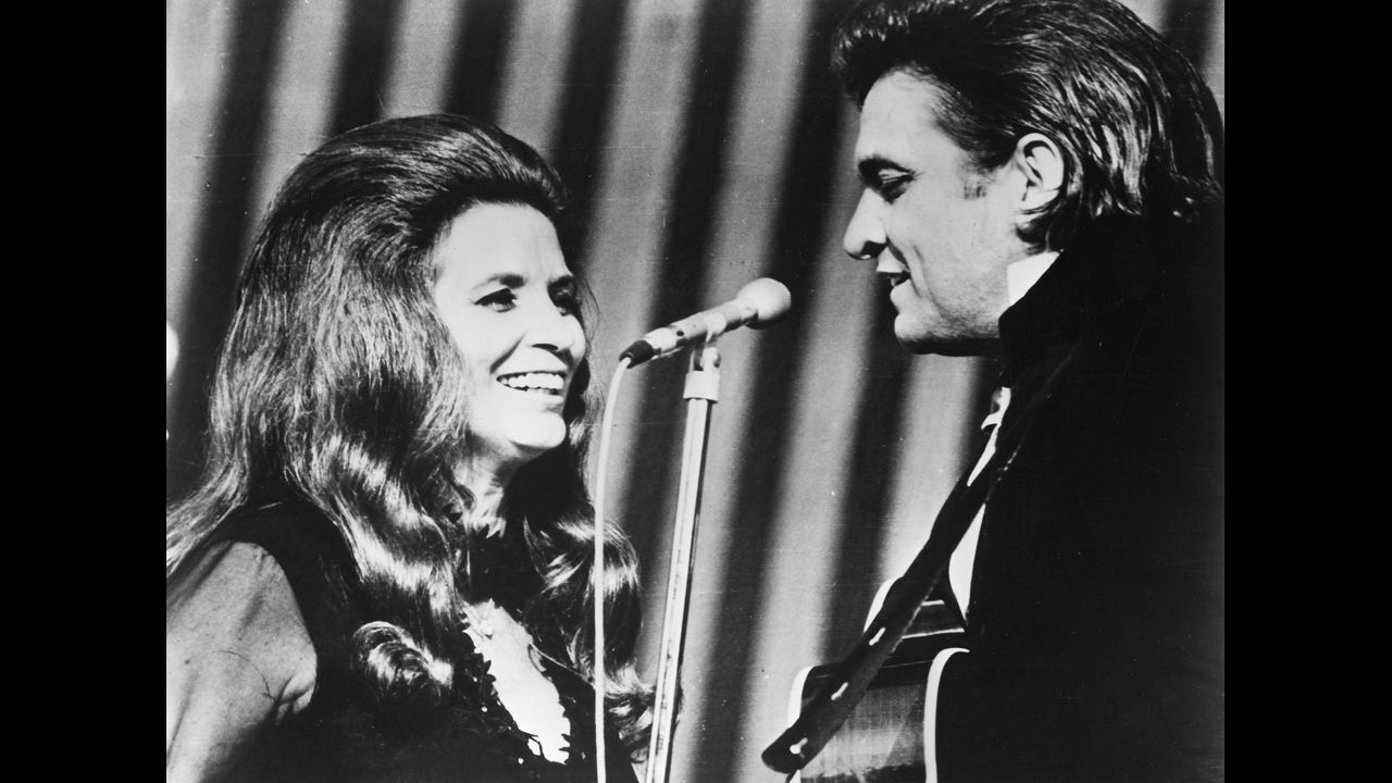 Johnny Cash and June Carter perform onstage circa 1970.