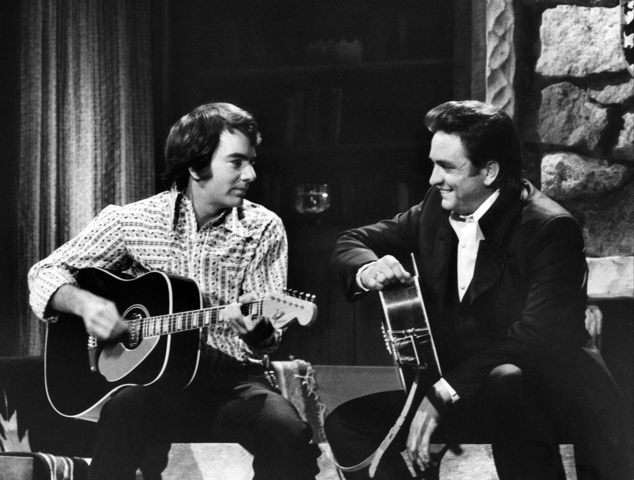 Cash, right, and Neil Diamond appear on "The Johnny Cash Show" aired on February 11, 1970.