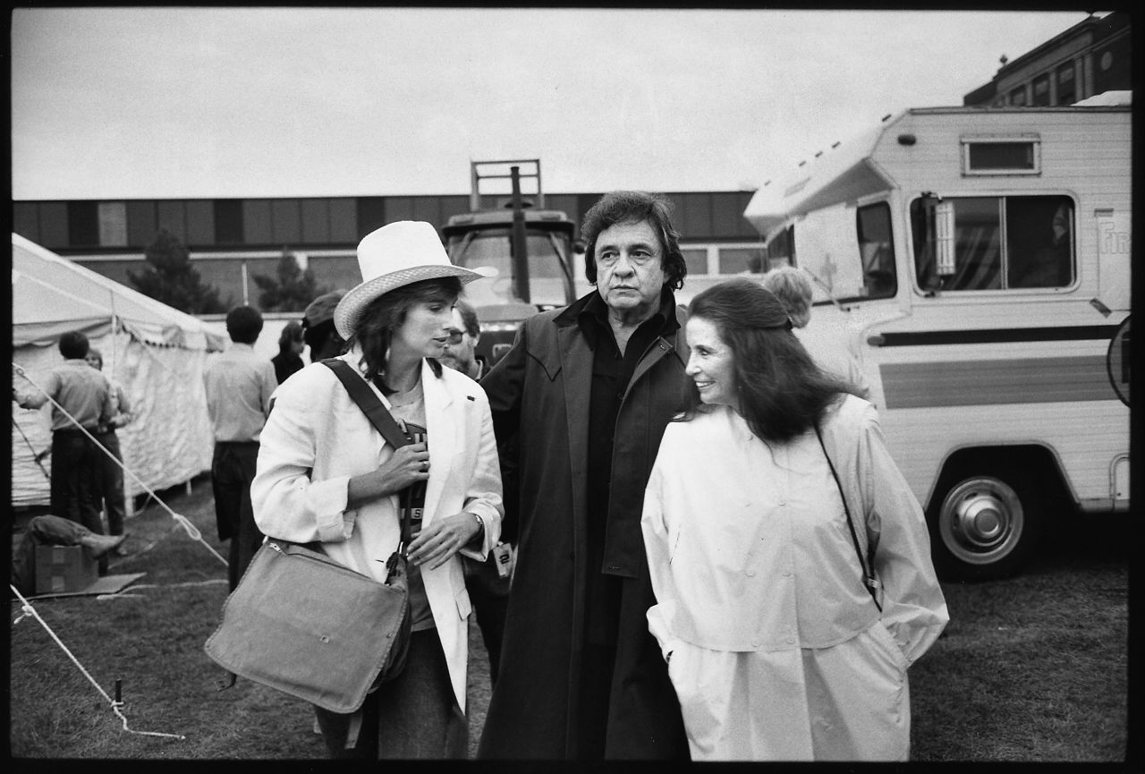 Emmylou Harris, from left, Johnny Cash and June Carter Cash chat at the Farm Aid Concert in Illinois in 1985.
